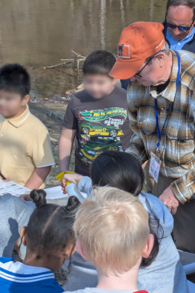 Children learning outdoors with adult
