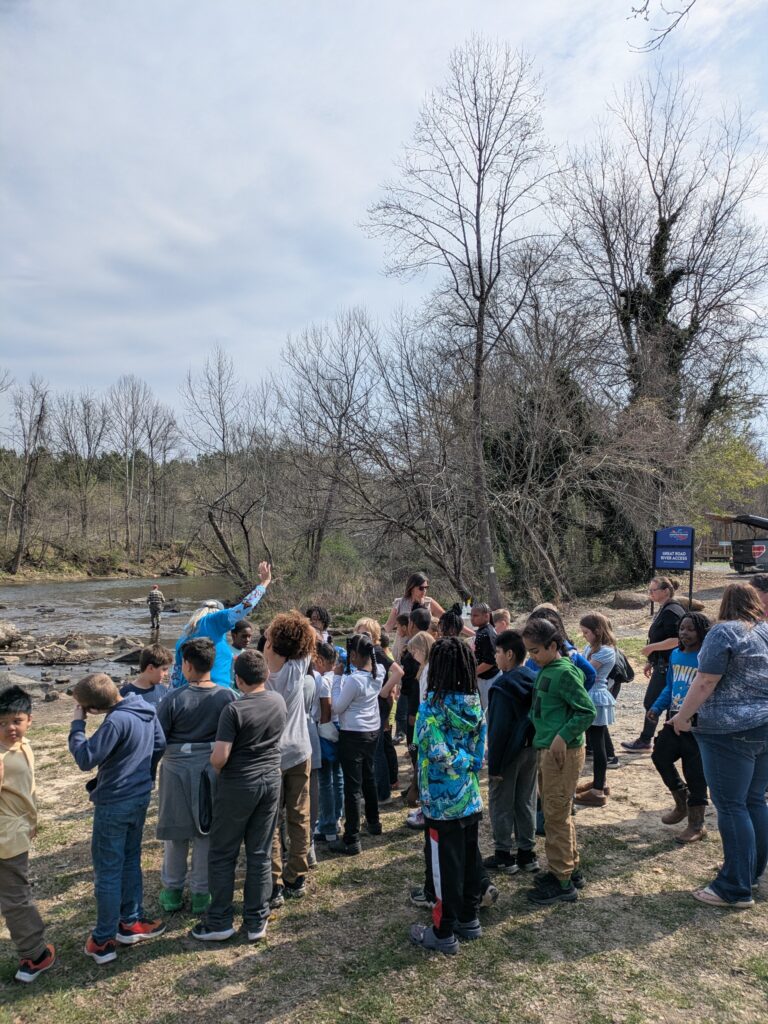 Children gathered around along a river